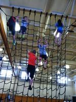 students climbing on a net